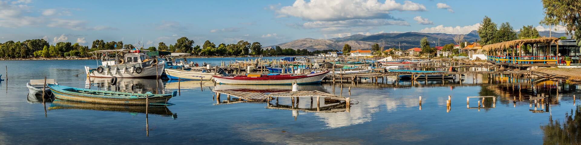 Panorama of the pier of fishing boats in Tourlida, Mesologi on a colorful cloudy day, Greece
