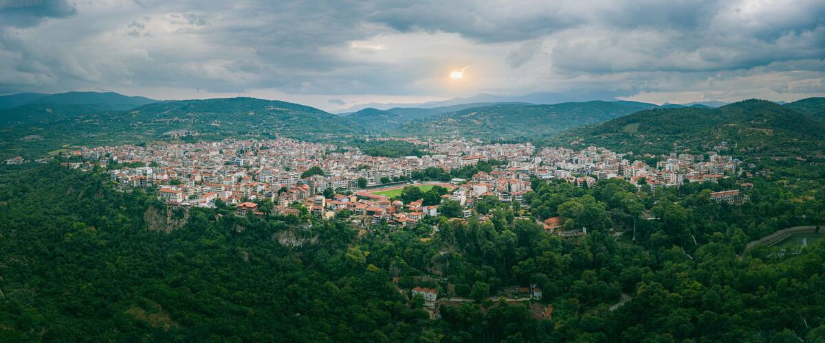 A city nestled in a valley surrounded by mountains.