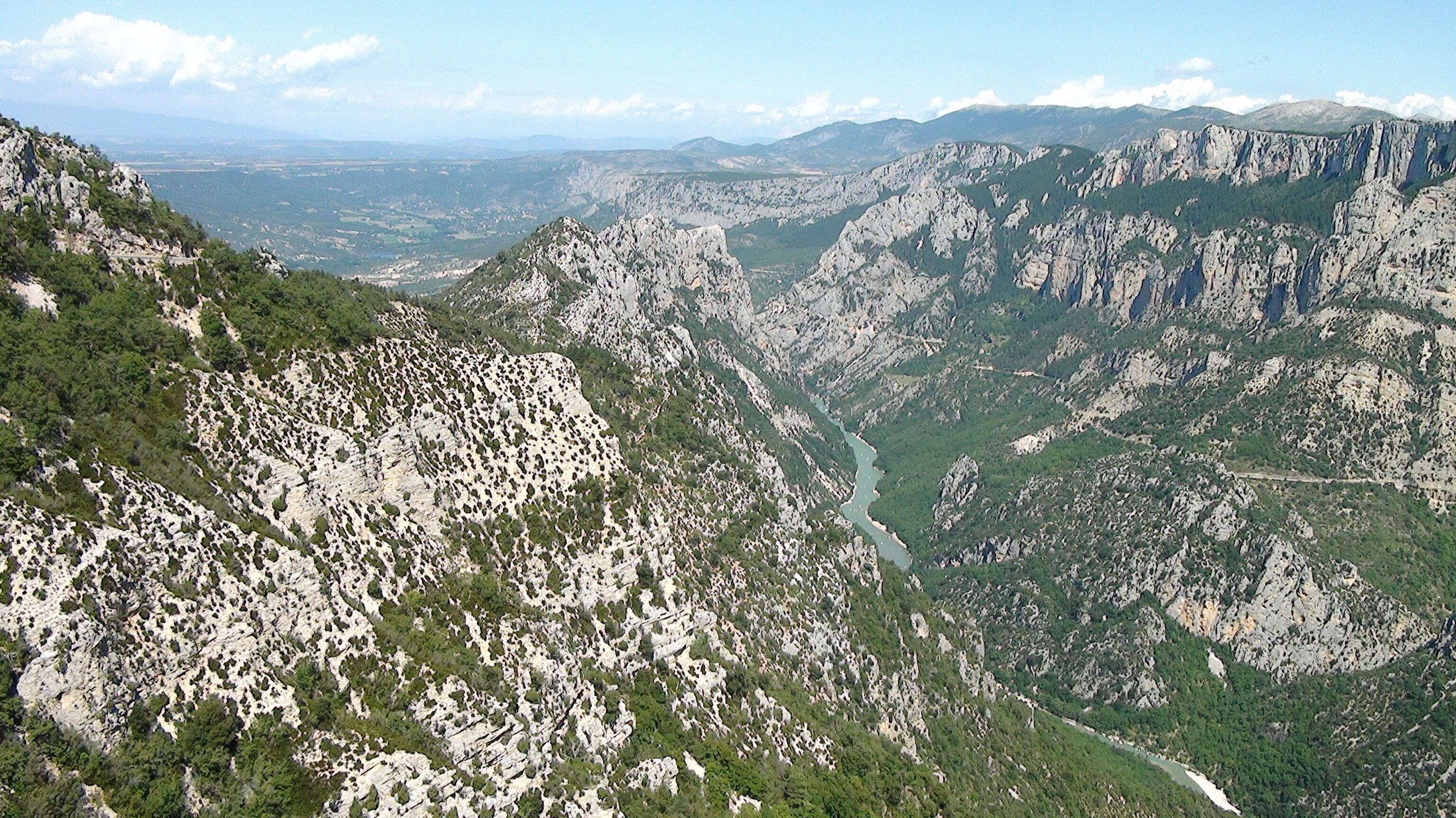 A mountainous landscape with rocky terrain and a river valley.