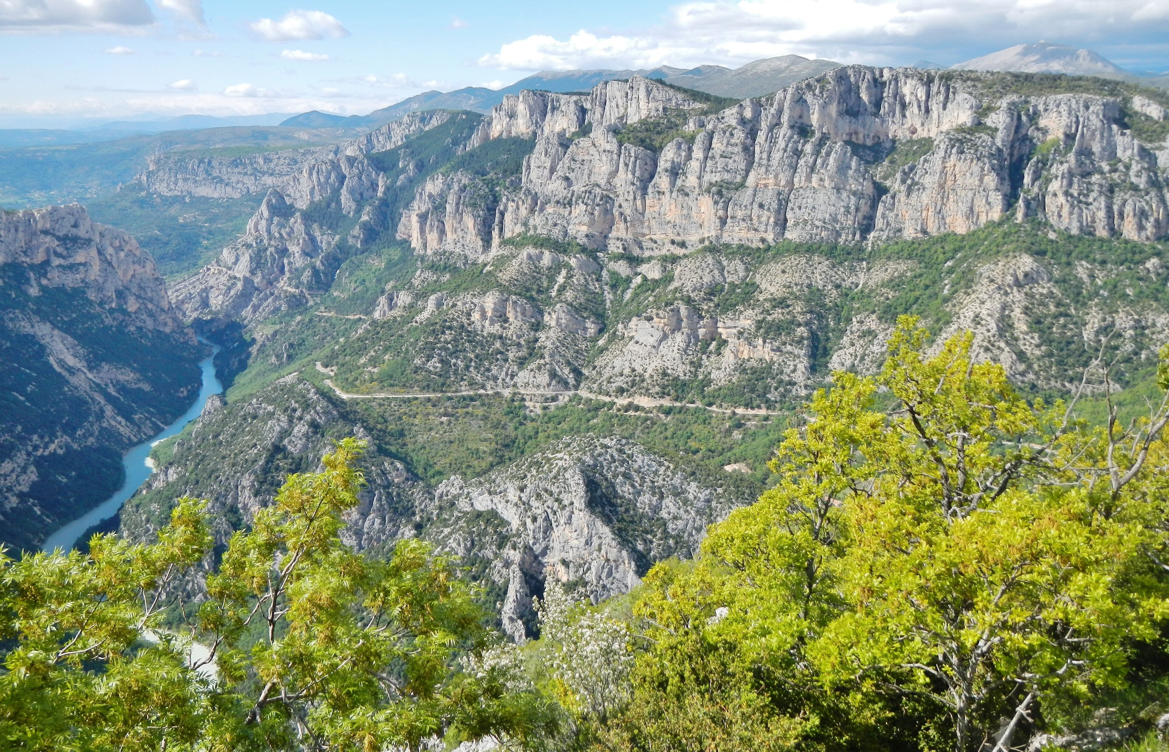 A mountainous landscape with rocky cliffs and a river.