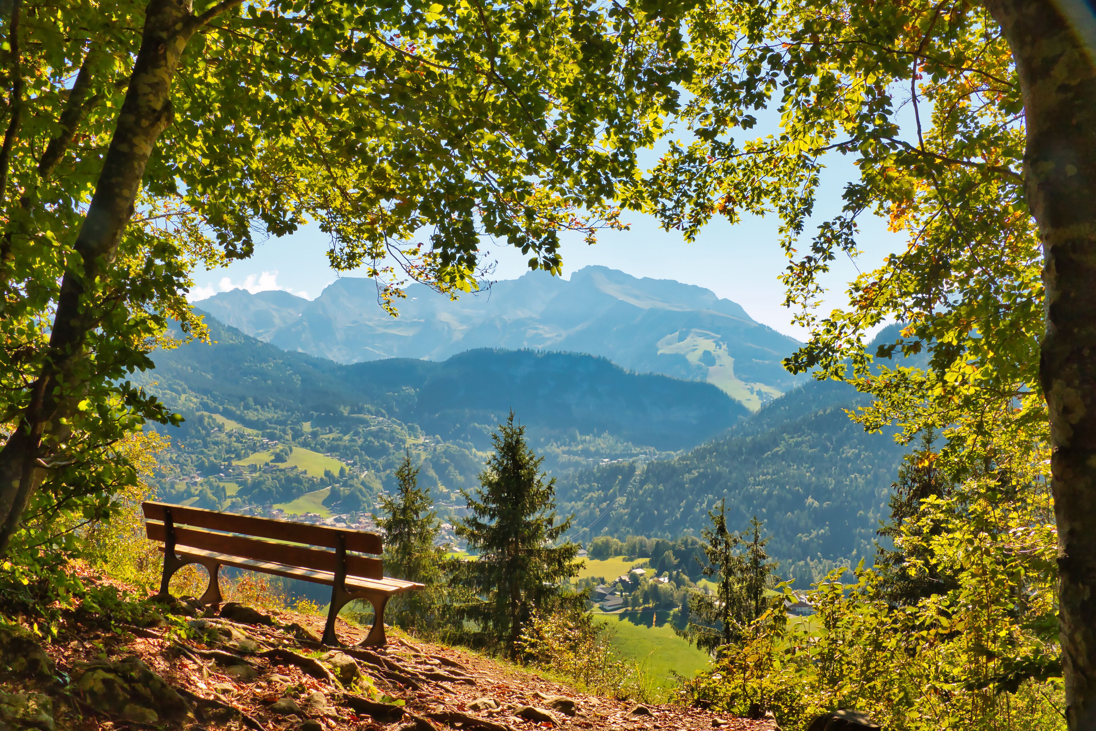 Bench on a vantage point high above Saint-Jean-de-Sixt, Haute-Savoie, France, with a panoramic view of the Aravis Range, a Natura 2000 site..
