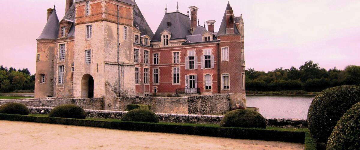 A historic château with multiple towers and a moat.