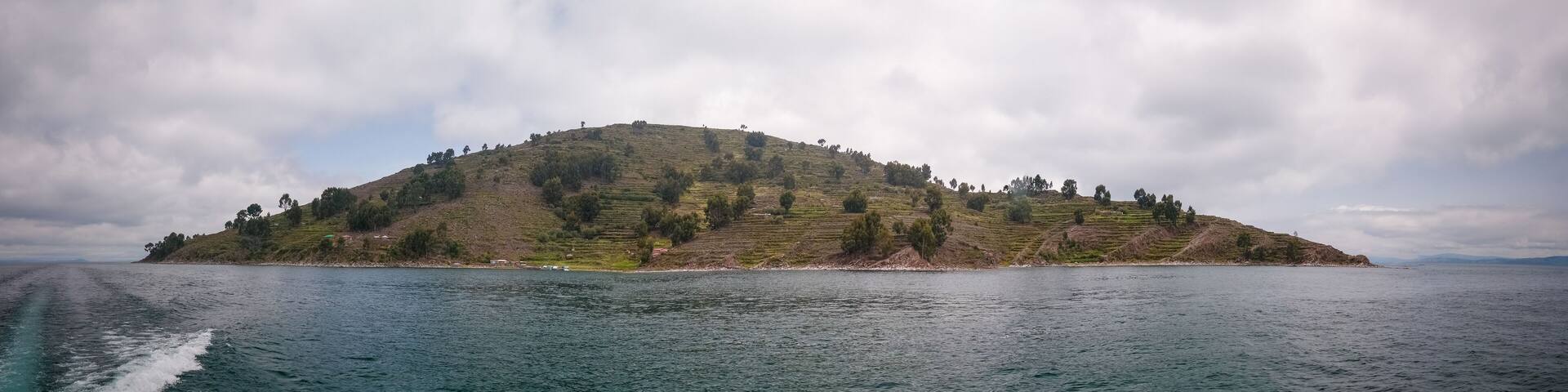 Panoramic view to Taquile island coastline at Titicaca lake in Puno, Peru