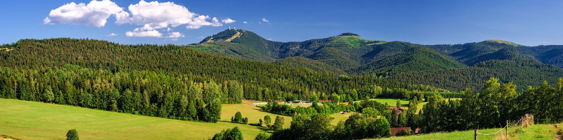 A mountainous landscape with a village nestled among the hills.