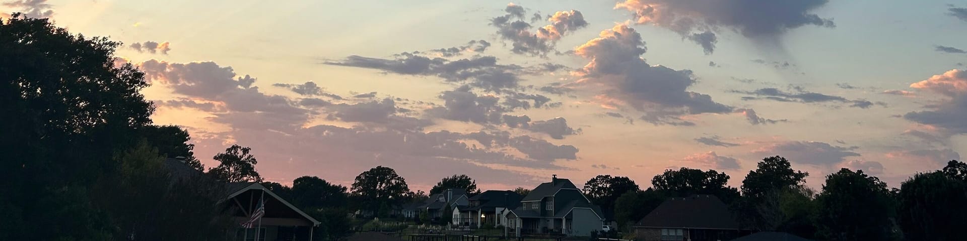 Colorful sunset clouds over Cedar Creek Reservoir waterfront in Texas