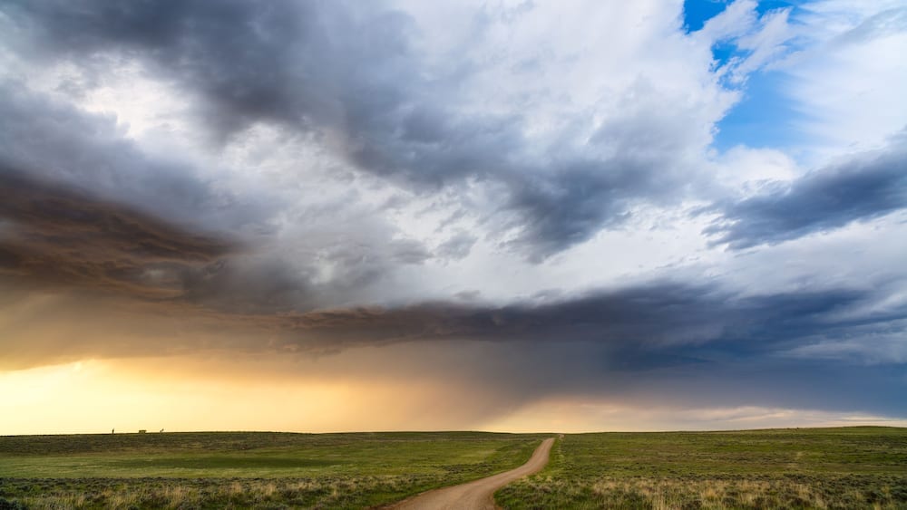 Scenic Wyoming landscape with rolling hills and dirt road in Thunder Basin National Grassland