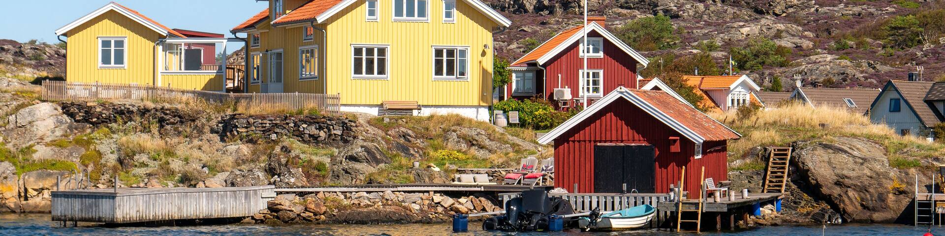 Wooden houses, boathouse and jetty in Kyrkesund coastal village, Tjörn island, Bohuslän, west coast Sweden
