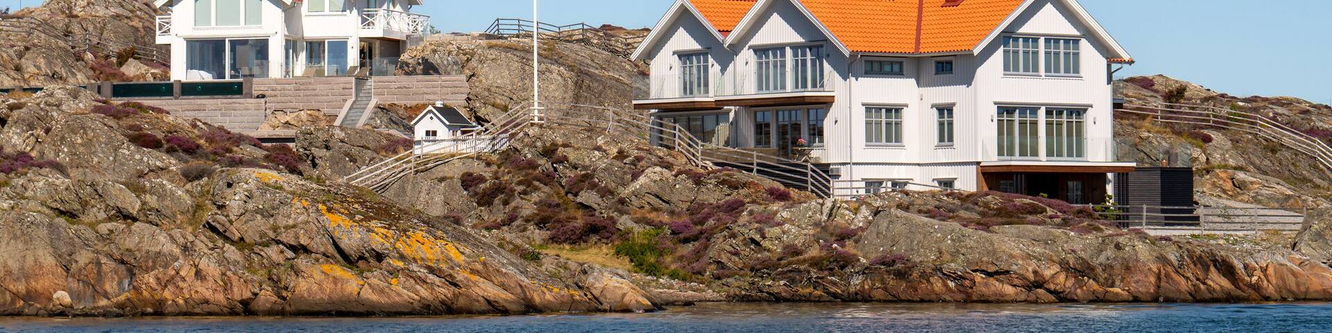 Coastal houses along rocky shoreline in Kyrkesund village on Härön island, Bohuslän, west coast Sweden