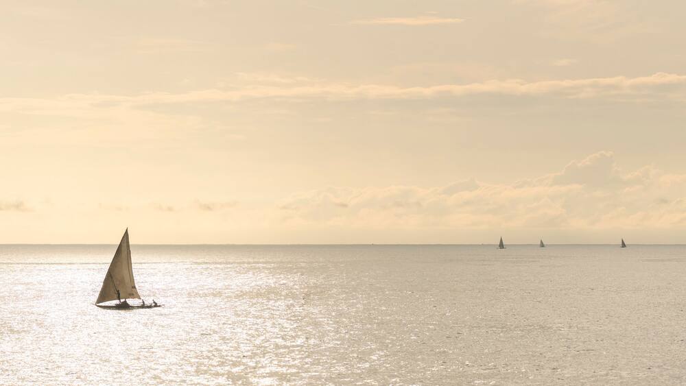 Dhow fishing boat at sunrise at Watamu Bay Beach, Watamu, Kilifi County, Kenya