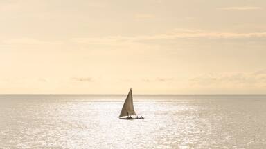 Dhow fishing boat at sunrise at Watamu Bay Beach, Watamu, Kilifi County, Kenya