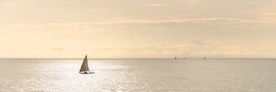 Dhow fishing boat at sunrise at Watamu Bay Beach, Watamu, Kilifi County, Kenya