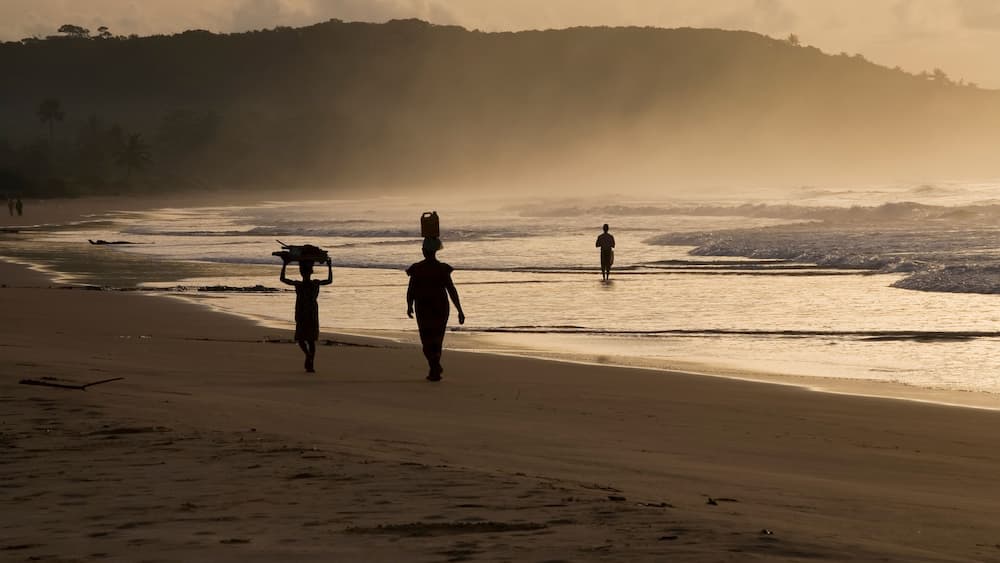 Woman and girl at sunrise. Busua Beach, Ghana