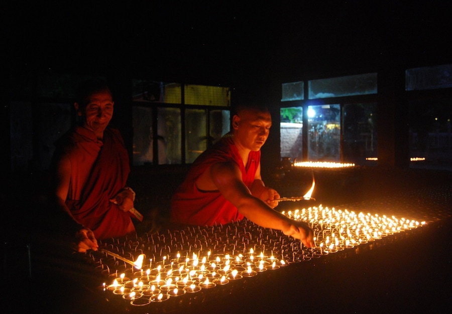 Buddhist monks light 'deeyas' (oil lamps) in the 'Prayer light room' in Mahabodhi Temple.
Its a sight to see as the room comes up with hundreds of 'deeyas'. You can also join in as volunteer and donate oil or candles to contribute.