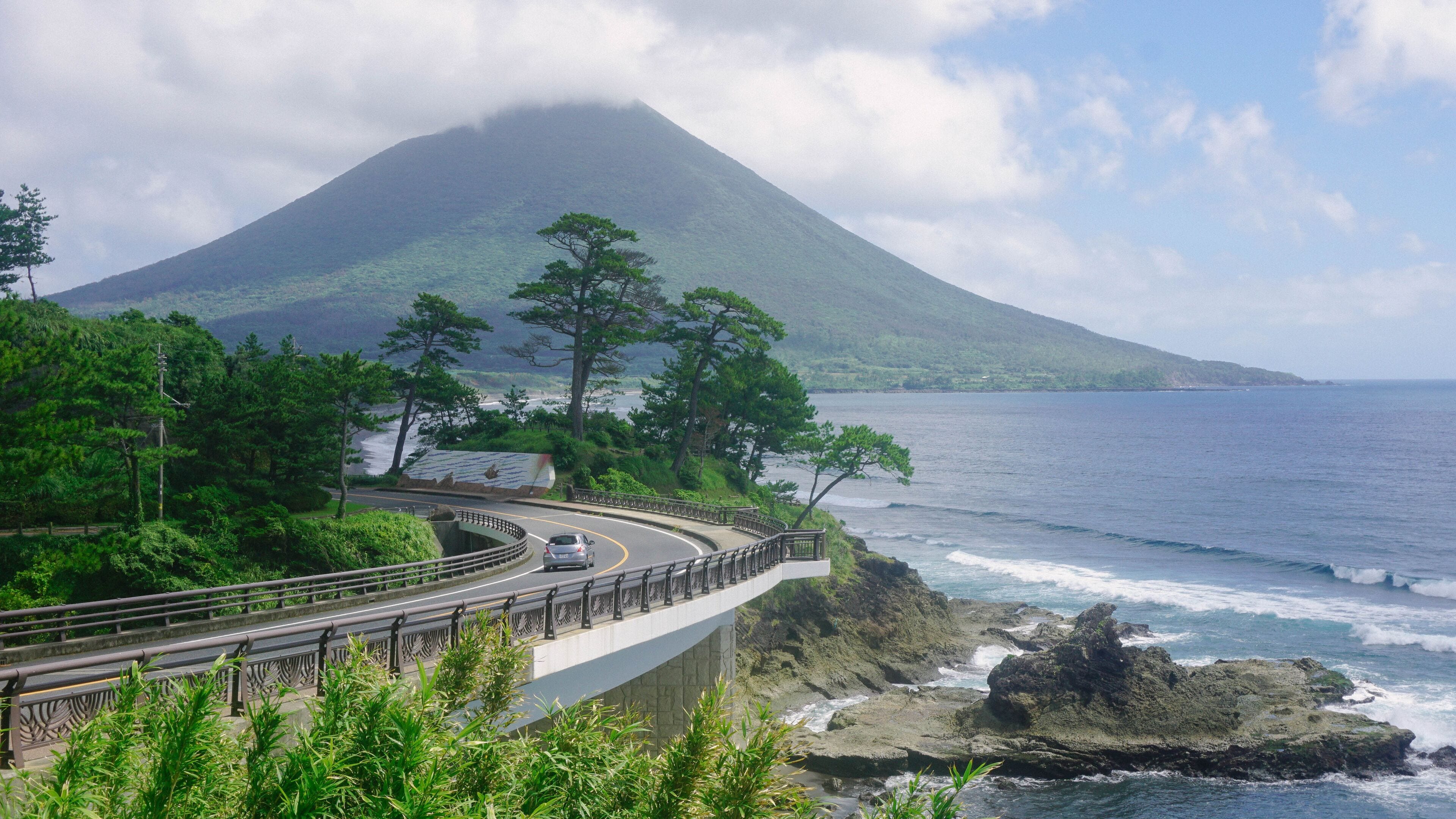 Aerial view of the bay with the highway into volcano mountain in Japan. Kaimondake Mountain,  Ibusuki, Kagoshima, 開聞岳 鹿児島県指宿市