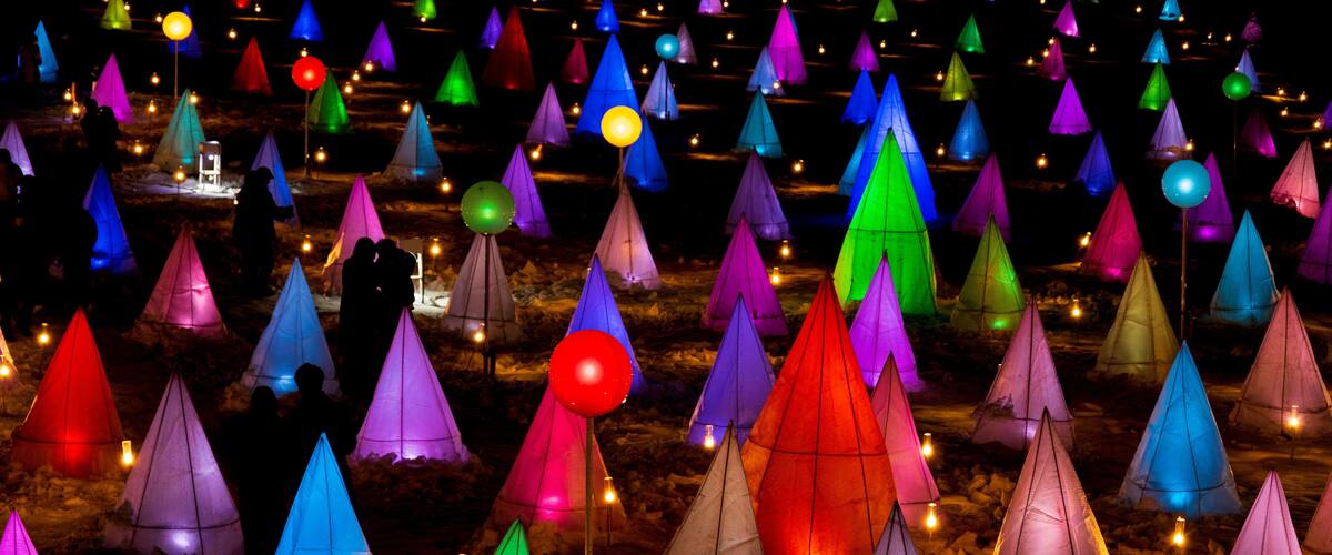 A field of colorful conical structures, possibly for a festival or event.