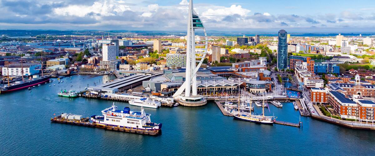 Aerial view of the sail-shaped Spinnaker Tower in Portsmouth Harbor in the south of England on the Channel coast - Gunwharf Quays modern shopping mall in a residential waterfront area