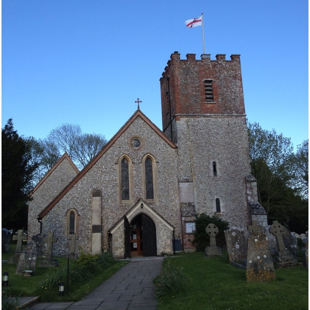 A church with a tower and a flag.