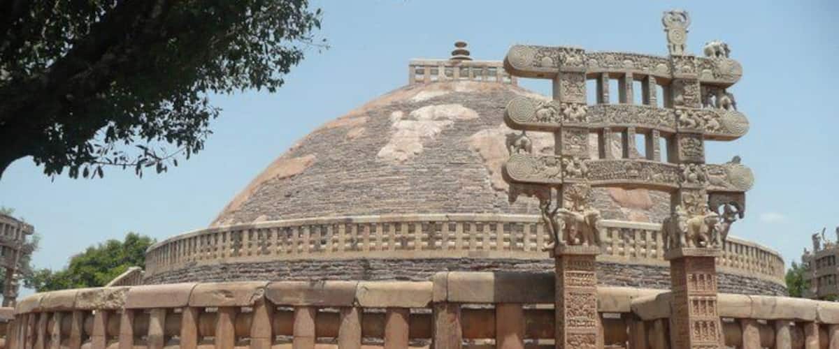 A large, domed structure with intricate carvings and a central spire.