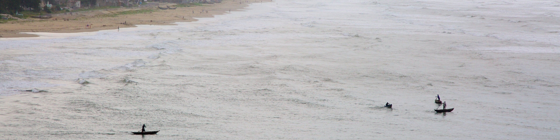 Lang Co which includes a coastal town, kayaking or canoeing and general coastal views