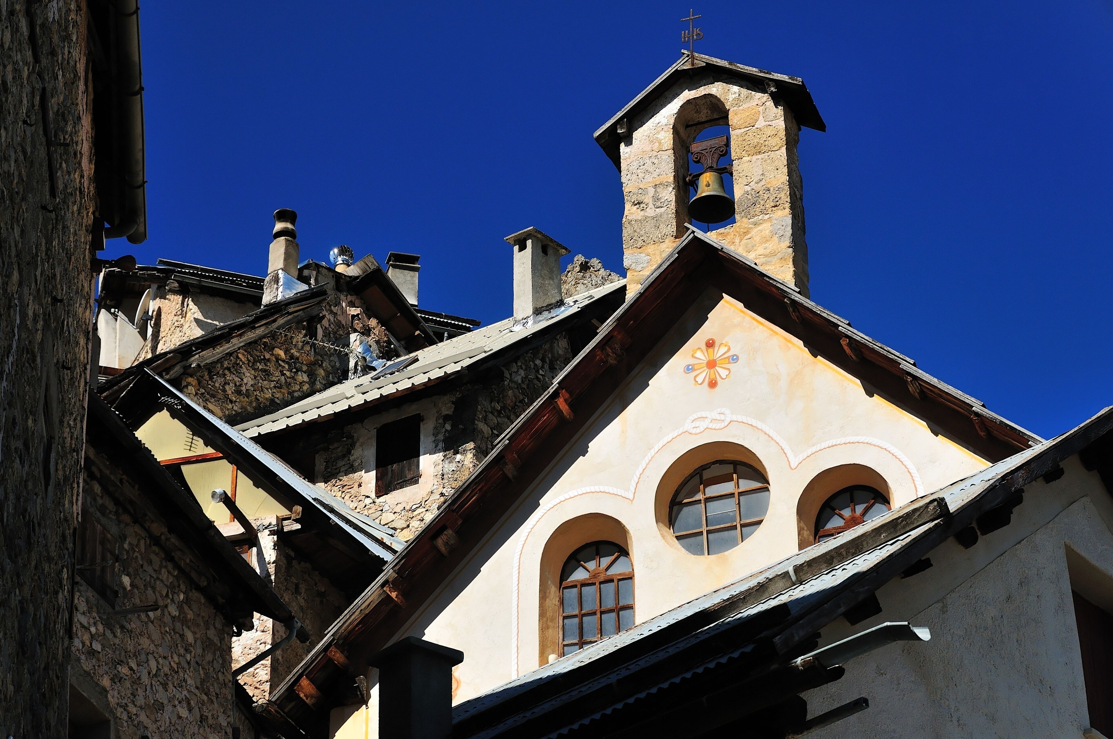 A church with a bell tower and arched windows.