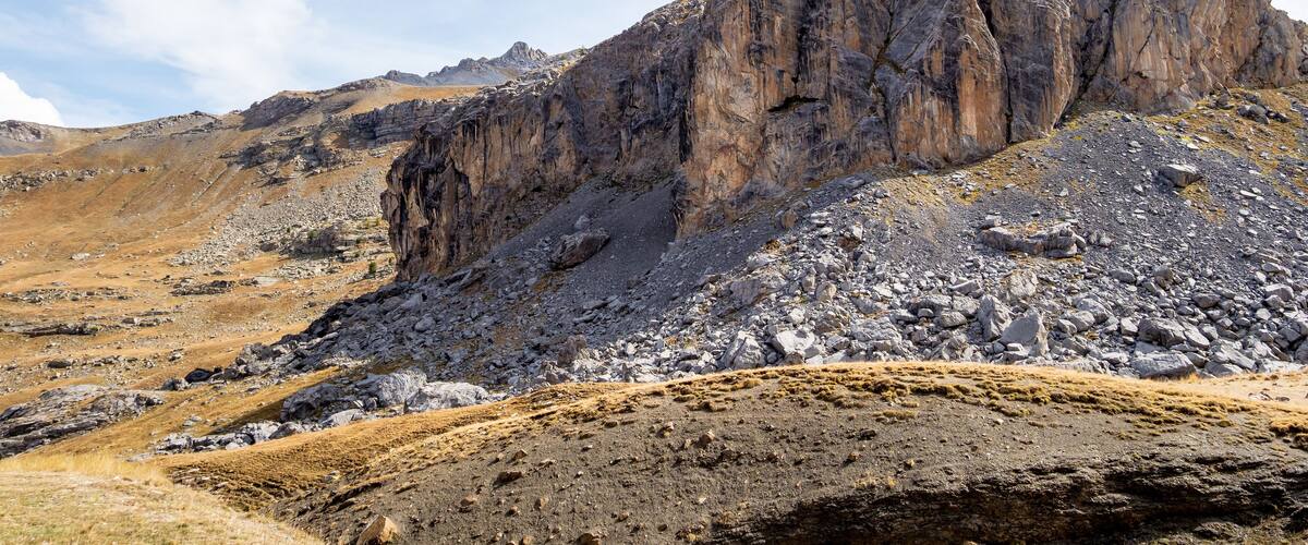 A rugged mountain landscape with rocky terrain and sparse vegetation.