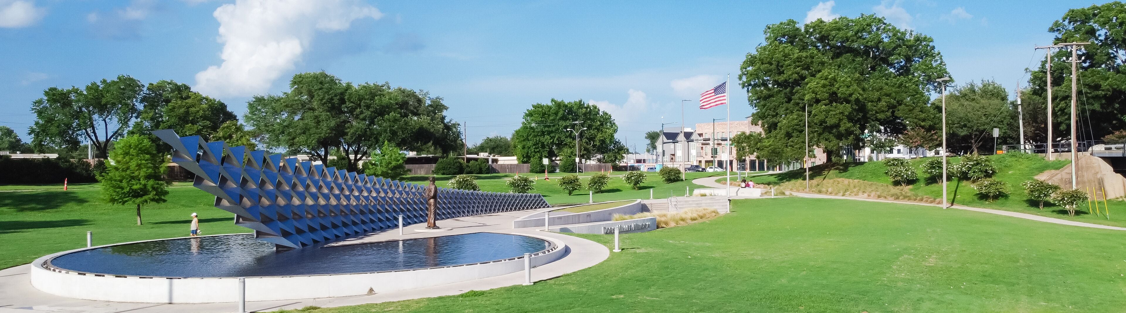 Panorama aerial view the metal panel installation representing of USS West Virginia in WWII, Doris Miller sculpture, American flag at memorial in Waco, Texas