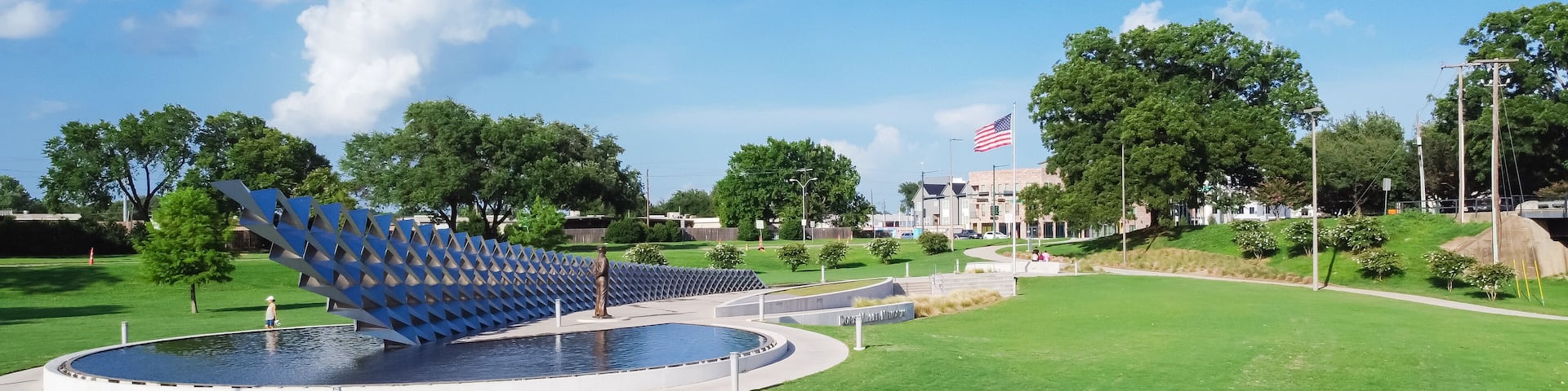 Panorama aerial view the metal panel installation representing of USS West Virginia in WWII, Doris Miller sculpture, American flag at memorial in Waco, Texas