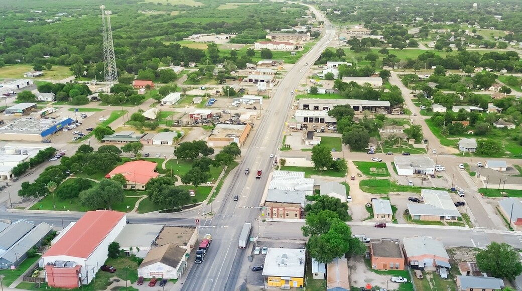 Panorama aerial view small town Three Rivers South of San Antonio along U.S. Highway 281, Texas, mix of industrial, business buildings and residential houses farmland, suburban rural, lush green