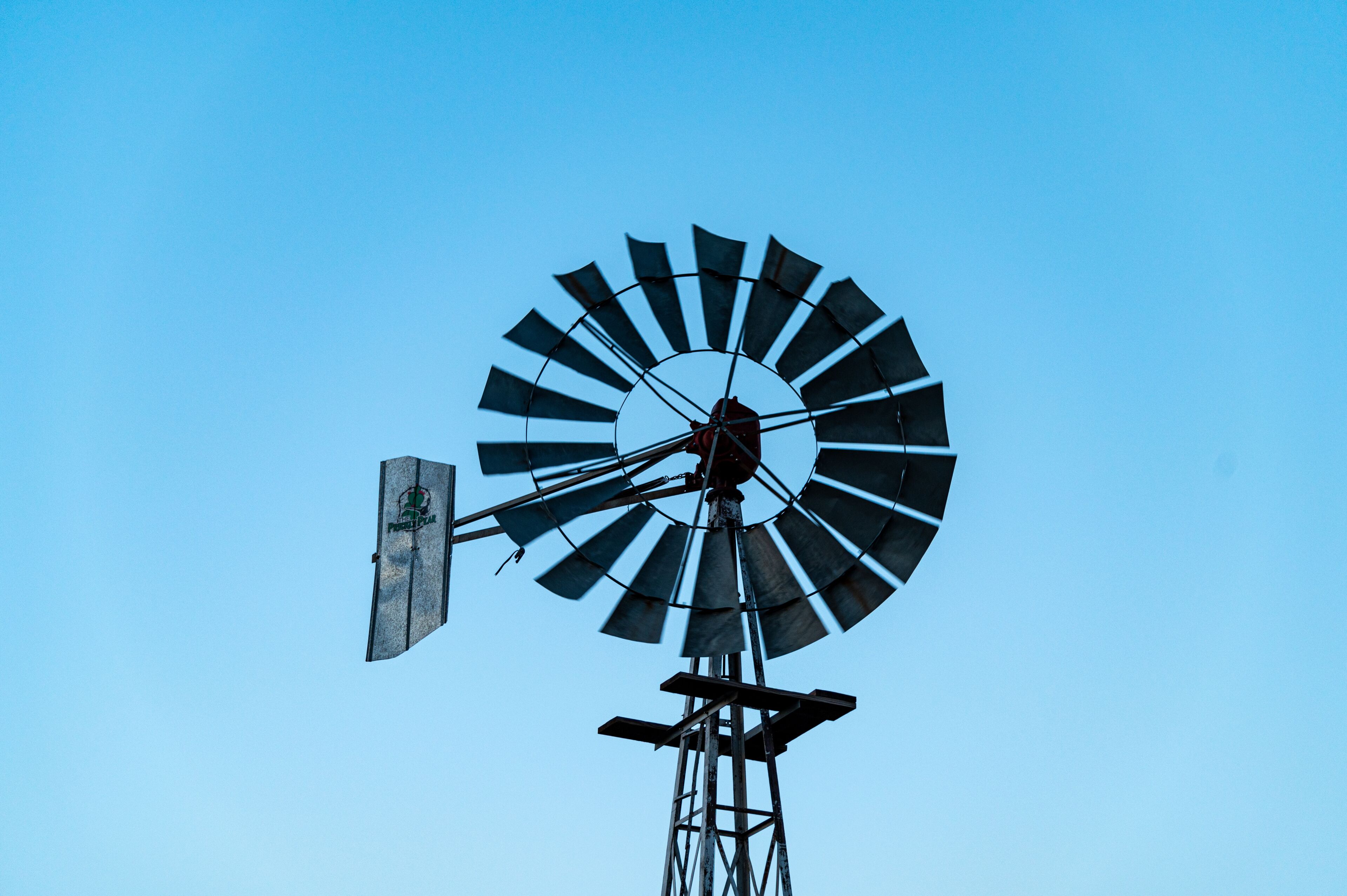 A windmill against a clear blue sky.