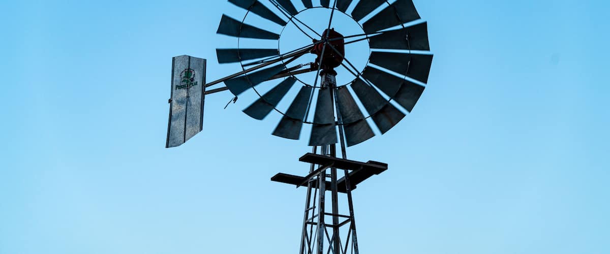 A windmill against a clear blue sky.