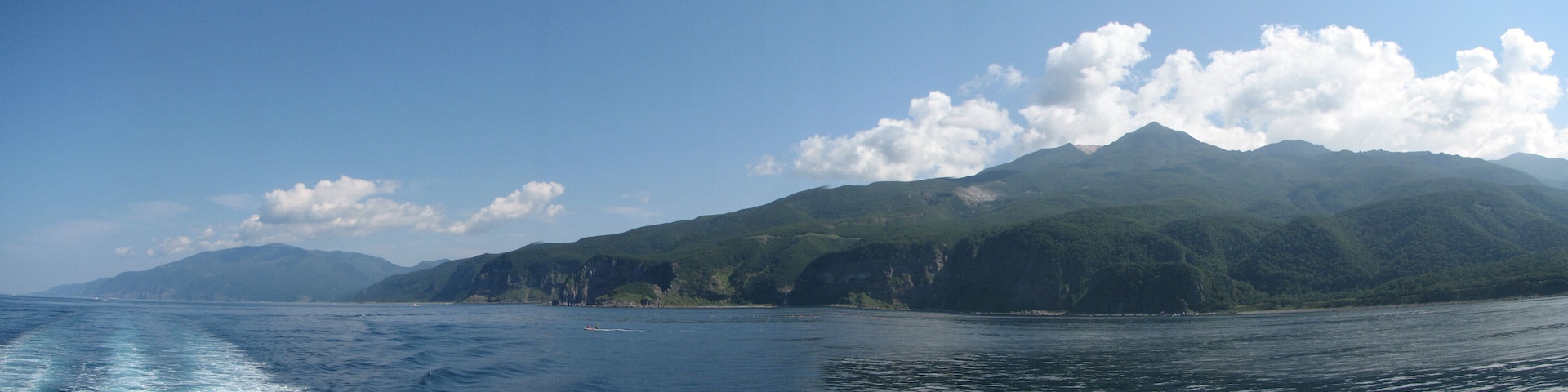 View of Shiretoko National Park. Mount Iō (right) and Mount Shiretoko (far left) seen from Sea of Okhotsk. Six seperate photos wer taken and stiched together with a software.