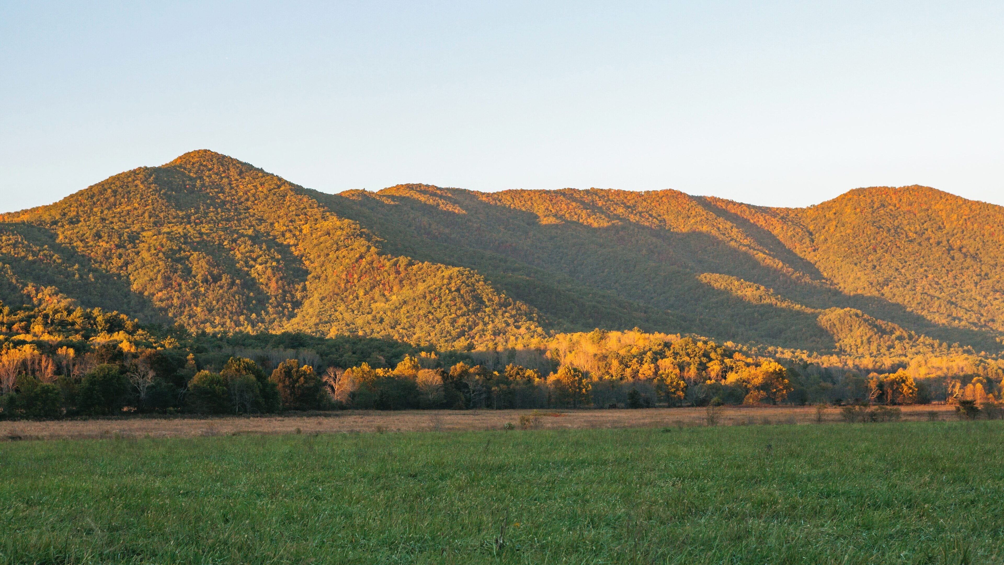 Stunning sunset view over Cades Cove in Townsend, Tennessee showcasing vibrant autumn foliage and rolling mountains