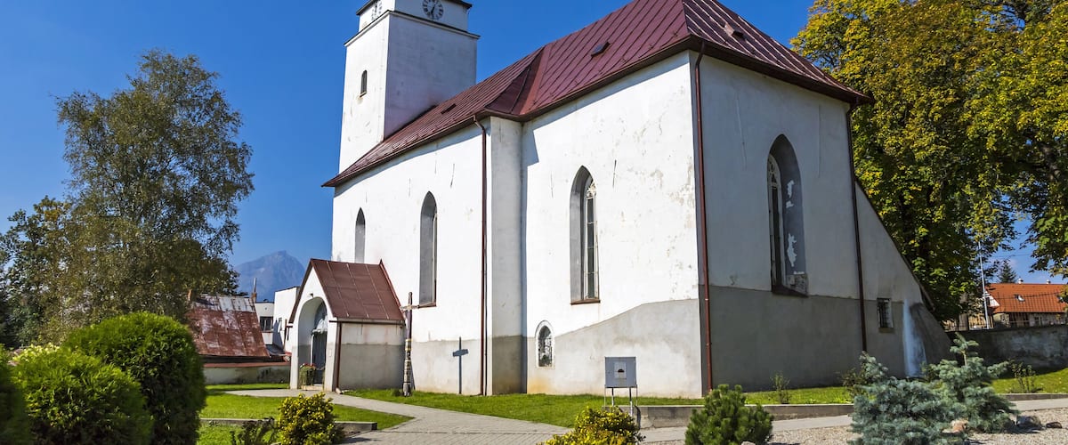 A church with a red roof and a bell tower.