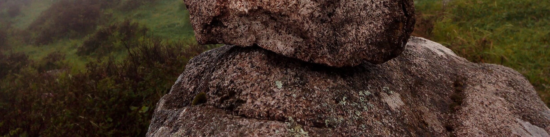 Rocks & sightseeing at the top of a mountain in a foggy day