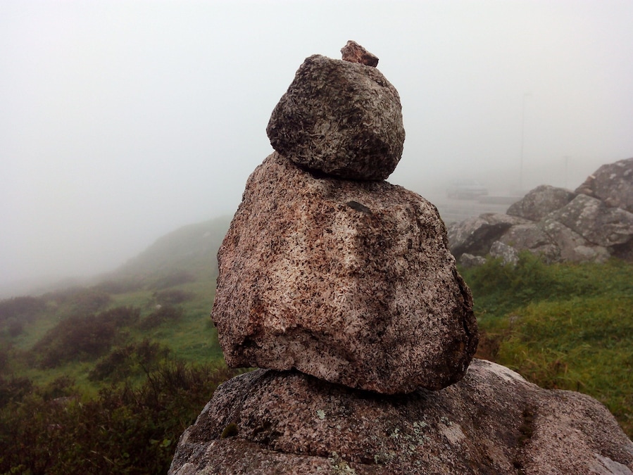 Rocks & sightseeing at the top of a mountain in a foggy day