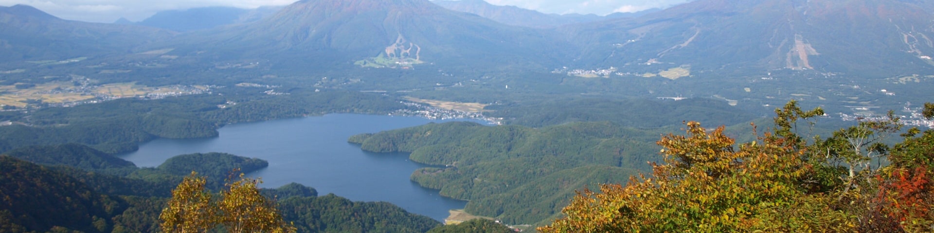 Myoko featuring tranquil scenes, mountains and a lake or waterhole