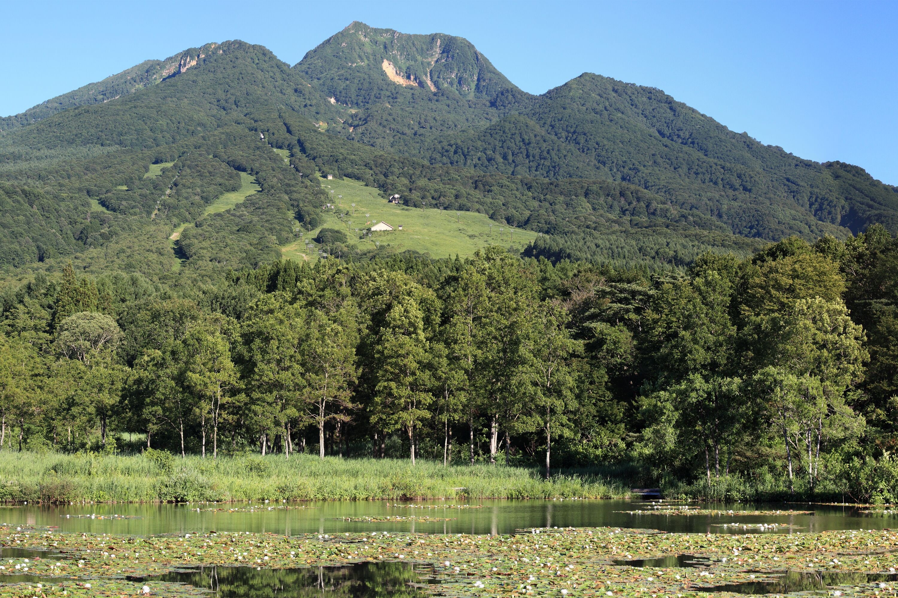 A mountain range with a lake in the foreground.
