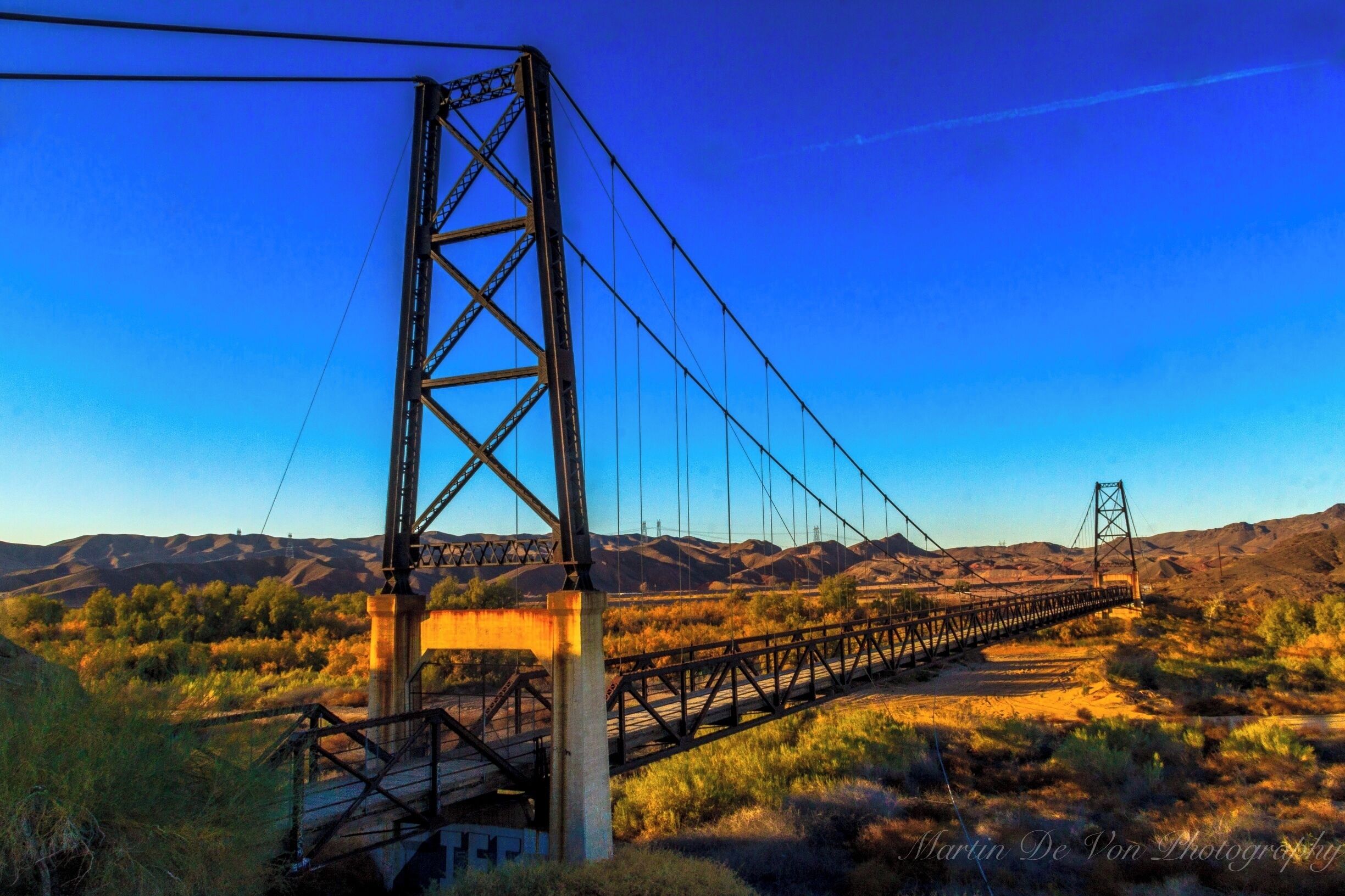 This 800-foot-long suspension bridge spanned the Gila River when it was built in 1929, and was named McPhaul Bridge in honor of Henry Harrison McPhaul, "the only Yuma resident who ever became an Arizona Ranger." But it was considered to be too flimsy for modern traffic, and when a dam was built upstream in 1968 the river was diverted and the highway was rerouted over a much smaller bridge. This ultimately proved unwise, as a flood in 1993 destroyed the new bridge while the Bridge to Nowhere, with its broad span and high clearance, probably would have been just fine.

