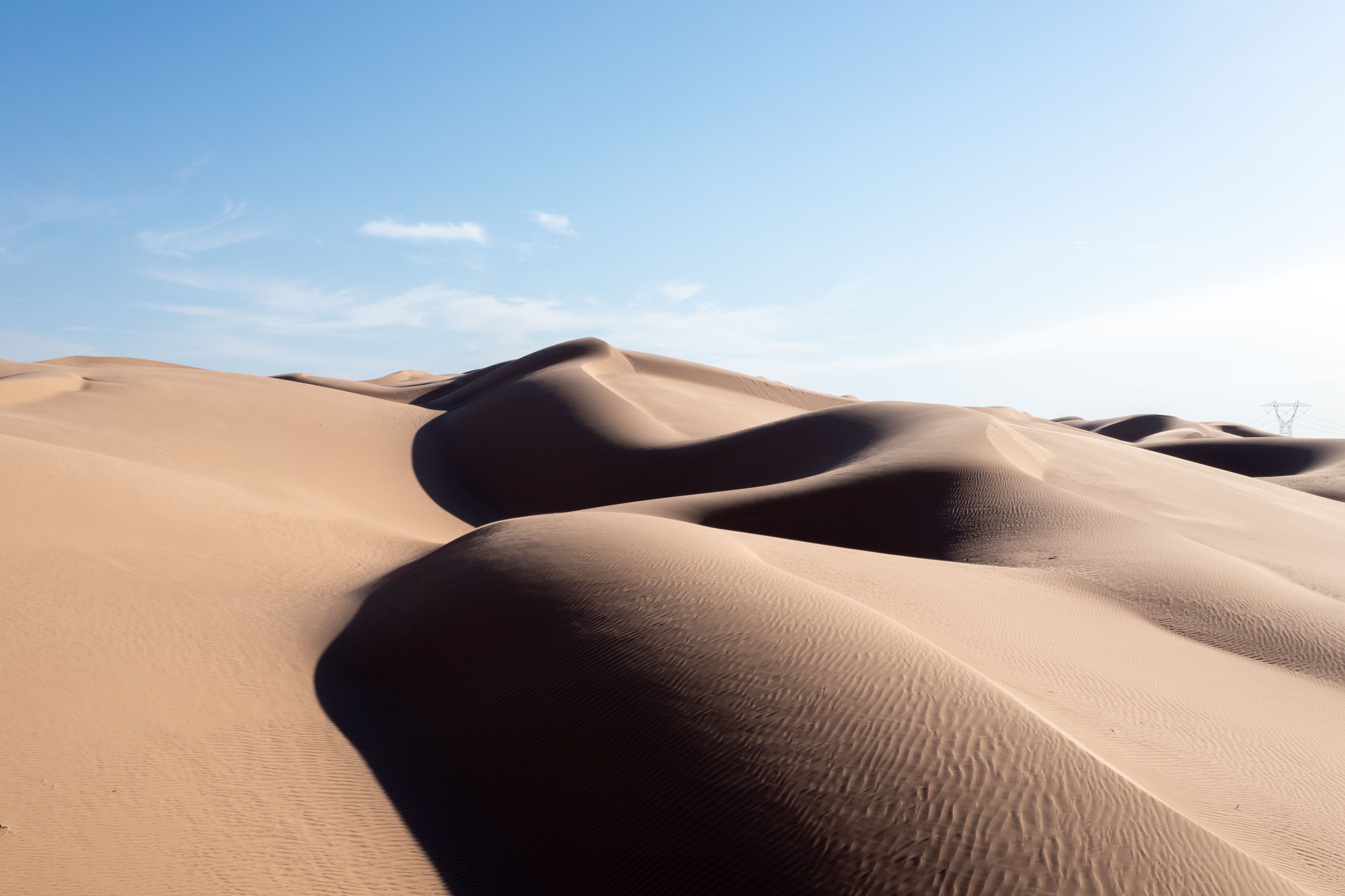 Sand dunes under a clear sky.