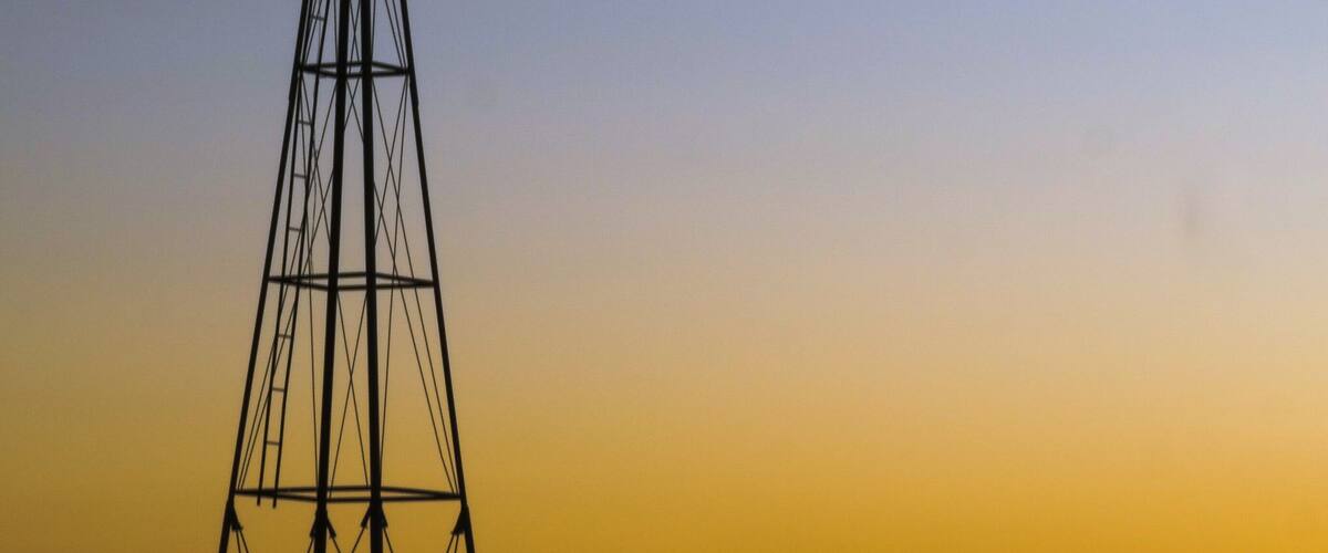 A windmill silhouetted against a sunset sky.