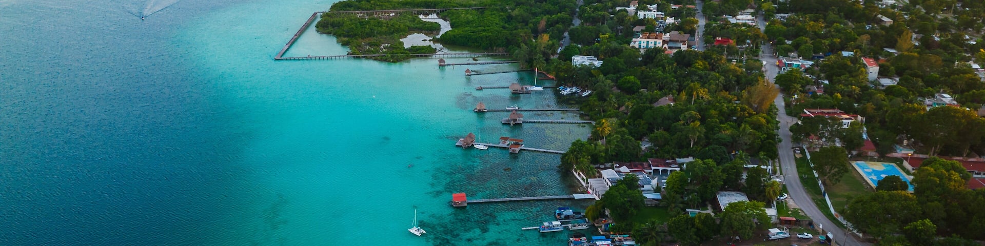 Seven colours lagoon in Bacalar Mexico resort beach town at sunset drone aerial footage