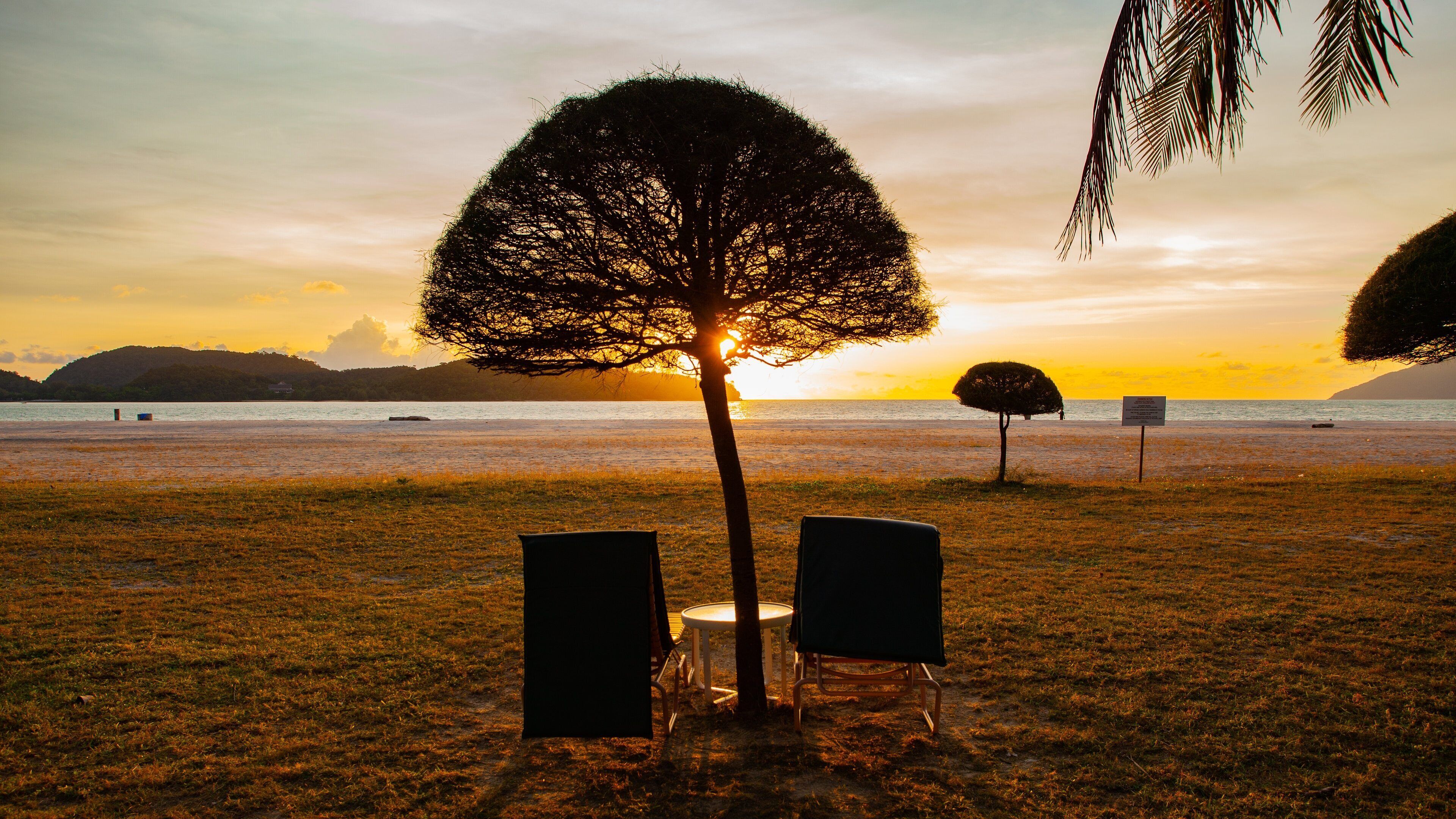 Kedah which includes a sunset, a sandy beach and tropical scenes