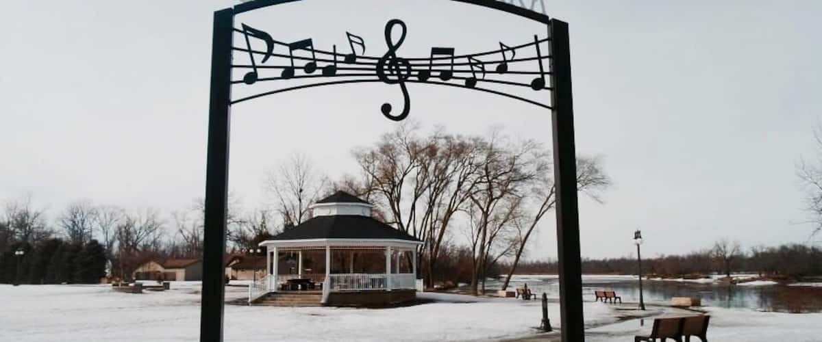 A gazebo in a park with a sign that reads "Celebration Park."