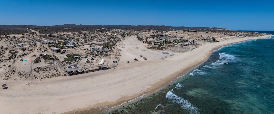 panoramic aerial landscape view of shoreline near La Fortuna, San José del Cabo, B.C.S. located on Baja California Sur, Mexico, with houses, buildings as well as wide white beach and rural landscape