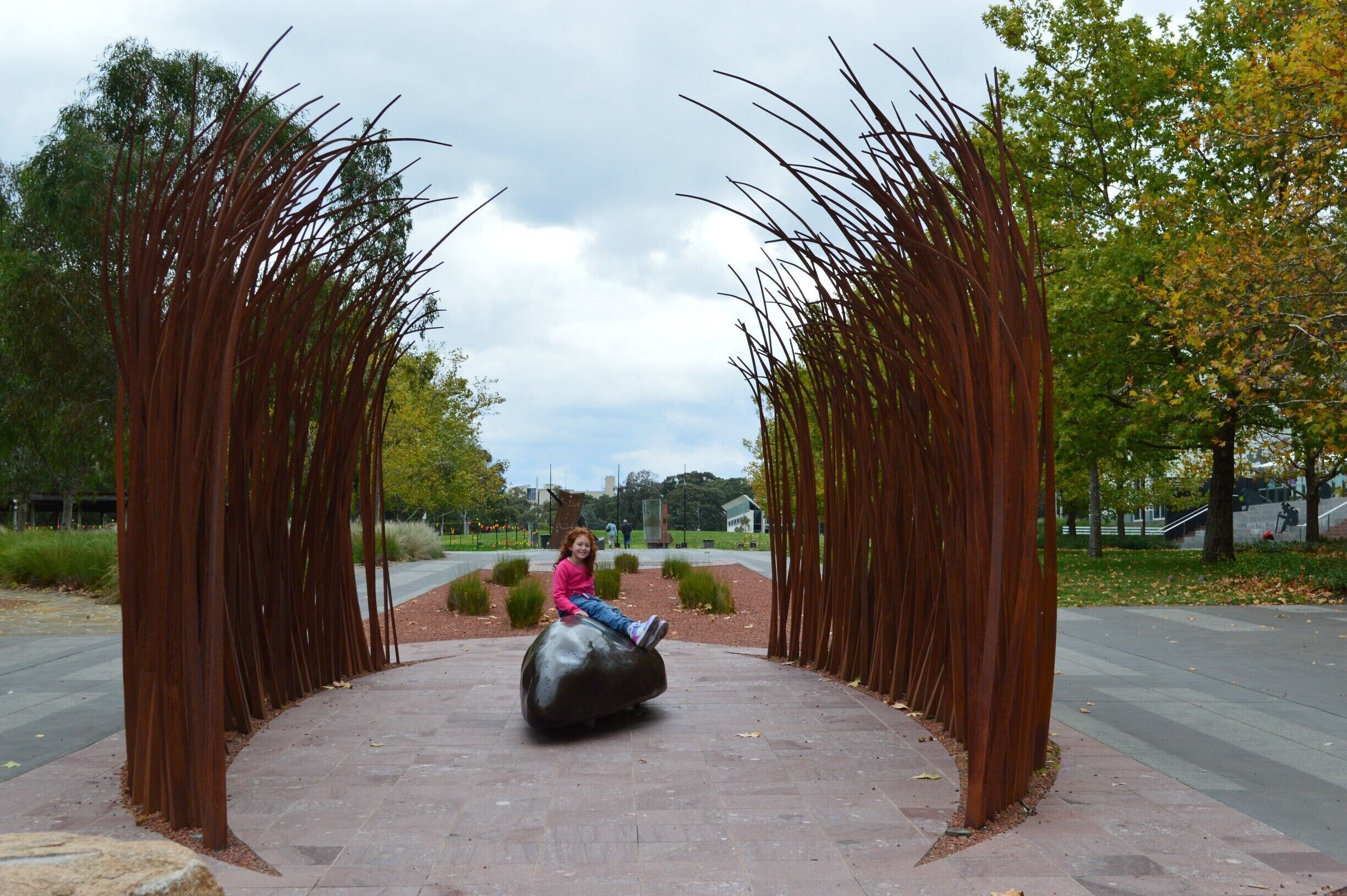 LET THE CREATIVE JUICES FLOW IN CANBERRA.
It seems that Canberra has the creative edge. 
For me personally, the next greatest enjoyment, second to travel is appreciating all forms of art. A random cyclist stopped to ask me my thoughts on the piece I was photographing … his words were ‘organic in form’ and ‘sublime’. Words which he felt the piece reflected. I too thought the same yet to others it may just be some metal strips and a brown lump with no form or connection. On closer inspection, the sculptural piece has another purpose. Utilising the wind, it would sing softly and only when close, you can hear its voice.
A piece of art or a sculpture can speak volumes and it can reflect on history reminding us of mistakes we hope to learn from. It can also be a simple piece which stands out as a funky inanimate object. I loved the giant pot plants outside the Beaver Gallery. Other pieces I enjoyed were in the sculptural gardens outside Questacon. 
Whatever your taste, it’s a place to be free in thought.
‪#‎Canberra‬#sculptures#art#appreciation