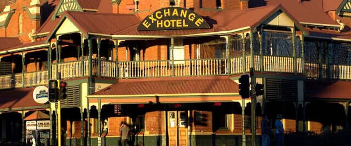 The Exchange Hotel with a prominent sign, a balcony, and a traditional architectural style.