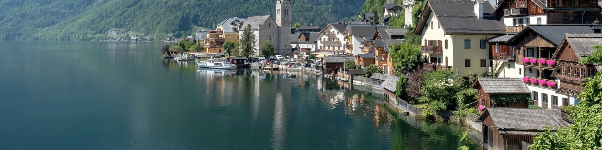 A picturesque Austrian village nestling by Lake Hallstatt, Hallstatt is arguably one of the most beautiful places in the world. Referred to as "the pearl of Austria", Hallstatt is famous for both the beauty of its architecture and the enchanting scenery that surrounds it. The traditional salt mining village dates back 800 years before Christ, and the salt mines that made its fame and fortune are the world's oldest. The village features houses that are built into the mountain rock, and it sits by a lake whose waters mirror the sky.