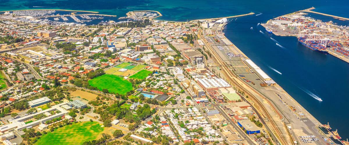 Aerial view of Fremantle Harbour, the Western Australia's largest and busiest general cargo port. Scenic flight over Fishing Boat Harbour, North Mole Lighthouse and Swan River, Australia. Copy space.