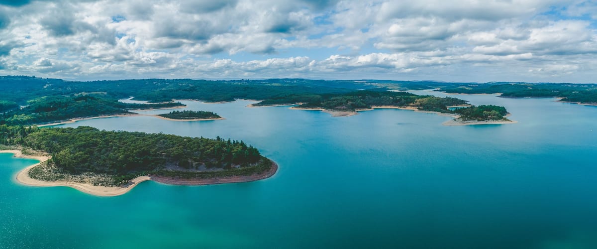 An aerial view of a coastal area with multiple islands surrounded by turquoise waters.