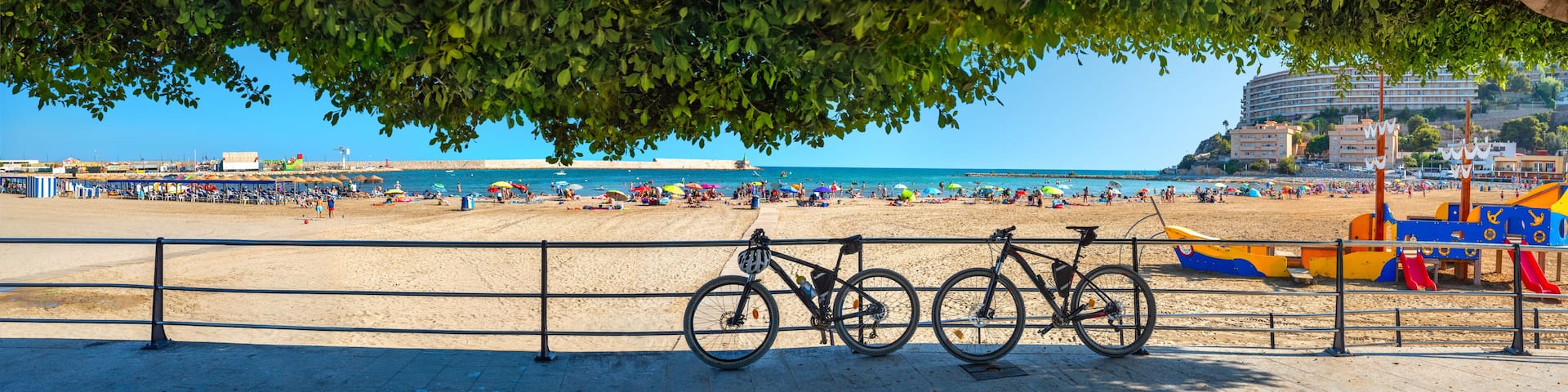 Panorama with sunny sand beach and waterfront at Peniscola. Castellon, Spain